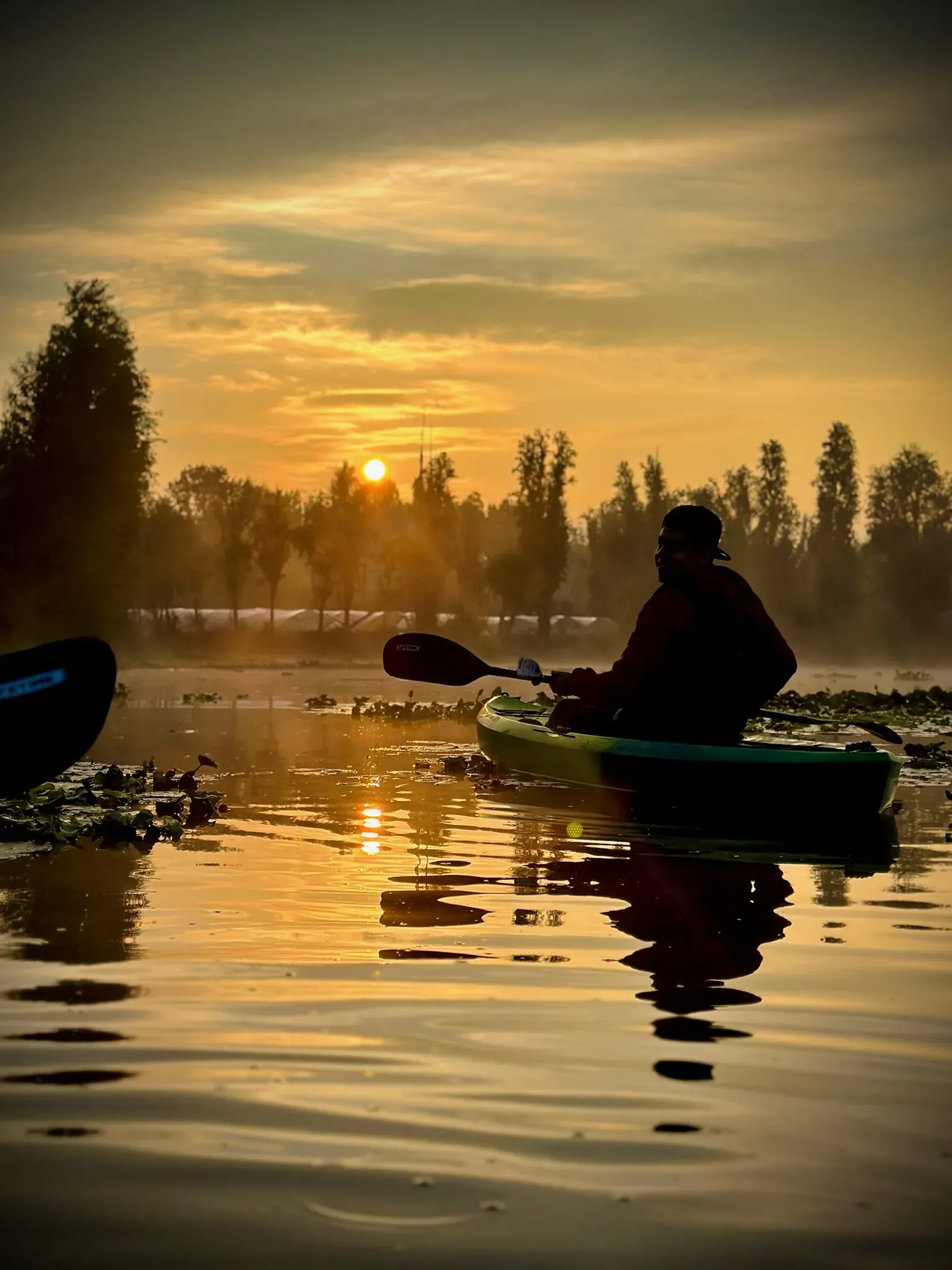 Persona en kayak en un canal estrecho de Xochimilco
